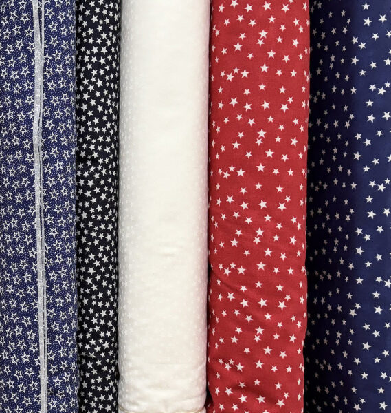 Red, white, and navy patriotic quilting fabrics with stars at Lady Bird Quilts