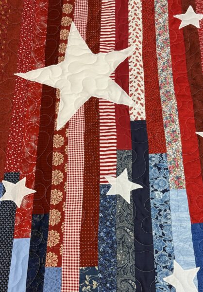 Close-up of an appliqued star with meander quilting on JoAnne Scafidi's patriotic quilt