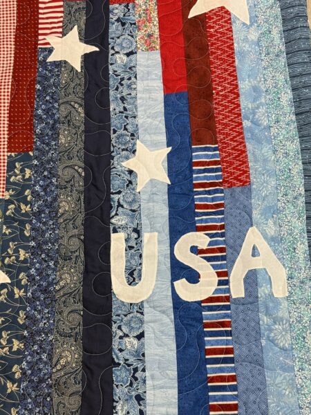 Close-up of the appliqued USA lettering on JoAnne Scafidi's patriotic quilt