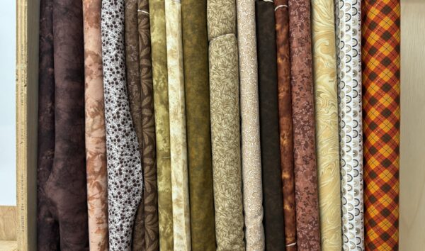 Dark brown tone cotton fabric bolts on the shelf