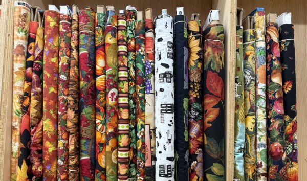 Harvest and fall print cotton fabric bolts on the shelf